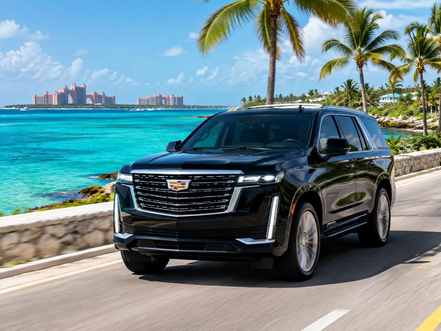 Black Cadillac Escalade driving along a coastal road in Nassau
